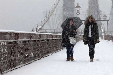 Women walk on the Brooklyn Bridge during a snowstorm in New York, March 8, 2013. A slow moving winter storm brought a combination of snow, r Women walk on the Brooklyn Bridge during a snowstorm in New York, March 8, 2013. A slow moving winter storm brought a combination of snow, r