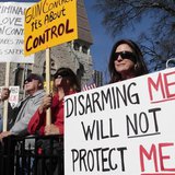Marylou Harris holds a sign as she listens to speakers during the Guns Across America pro-gun rally at the State Capitol in Atlanta, Georgia