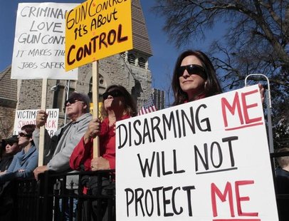 Marylou Harris holds a sign as she listens to speakers during the Guns Across America pro-gun rally at the State Capitol in Atlanta, Georgia Marylou Harris holds a sign as she listens to speakers during the Guns Across America pro-gun rally at the State Capitol in Atlanta, Georgia