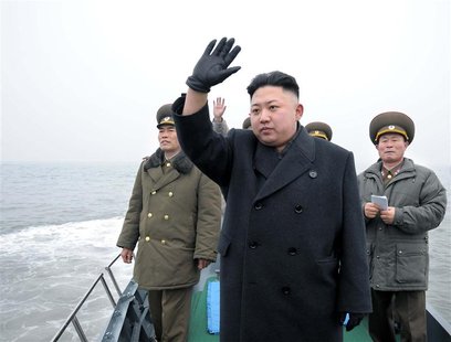 North Korean leader Kim Jong-Un (C) waves from a boat during his visit to the Jangjae Islet Defence Detachment and Mu Islet Hero Defence Det North Korean leader Kim Jong-Un (C) waves from a boat during his visit to the Jangjae Islet Defence Detachment and Mu Islet Hero Defence Det