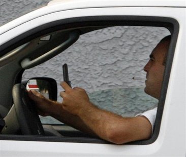 A man uses a cell phone while driving in Burbank, California June 25, 2008. REUTERS/Fred Prouser A man uses a cell phone while driving in Burbank, California June 25, 2008. REUTERS/Fred Prouser