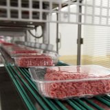 Packages of ground beef make their way down a conveyor belt at the Fresh & Easy Neighborhood Market meat processing facility in Riverside, C Packages of ground beef make their way down a conveyor belt at the Fresh & Easy Neighborhood Market meat processing facility in Riverside, C