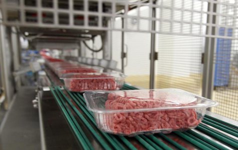 Packages of ground beef make their way down a conveyor belt at the Fresh & Easy Neighborhood Market meat processing facility in Riverside, C Packages of ground beef make their way down a conveyor belt at the Fresh & Easy Neighborhood Market meat processing facility in Riverside, C