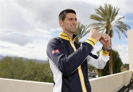 Novak Djokovic of Serbia celebrates correctly answering a trivia question about a fellow tennis player while he is interviewed at the BNP Pa Novak Djokovic of Serbia celebrates correctly answering a trivia question about a fellow tennis player while he is interviewed at the BNP Pa