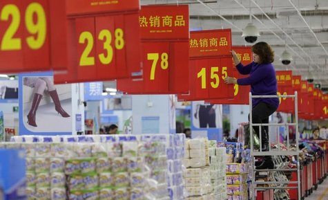 A worker adjusts a price tag at a supermarket in Wuhan, Hubei province, November 9, 2012. REUTERS/Stringer A worker adjusts a price tag at a supermarket in Wuhan, Hubei province, November 9, 2012. REUTERS/Stringer
