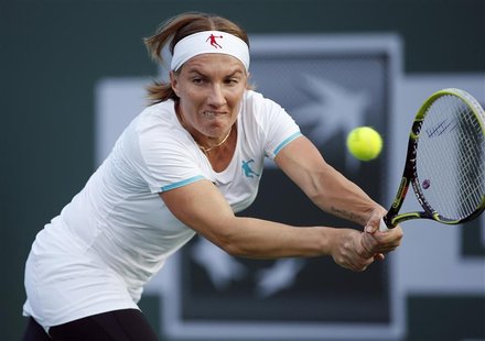 Svetlana Kuznetsova of Russia returns a shot against Jelena Jankovic of Serbia during their match at the BNP Paribas Open WTA tennis tournam Svetlana Kuznetsova of Russia returns a shot against Jelena Jankovic of Serbia during their match at the BNP Paribas Open WTA tennis tournam