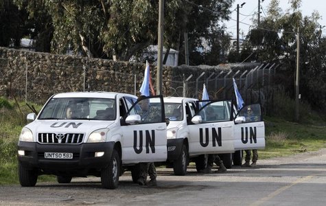United Nations peacekeepers put on protective gear before driving through the Kuneitra border crossing between Israel and Syria, in the Isra United Nations peacekeepers put on protective gear before driving through the Kuneitra border crossing between Israel and Syria, in the Isra