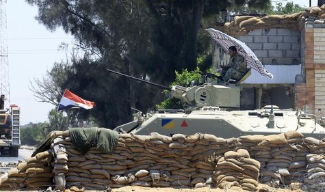 An Egyptian soldier guards a checkpoint at Rafah city, some 350 km (217 miles) northeast of Cairo August 9, 2012. REUTERS/Mohamed Abd El Gha An Egyptian soldier guards a checkpoint at Rafah city, some 350 km (217 miles) northeast of Cairo August 9, 2012. REUTERS/Mohamed Abd El Gha