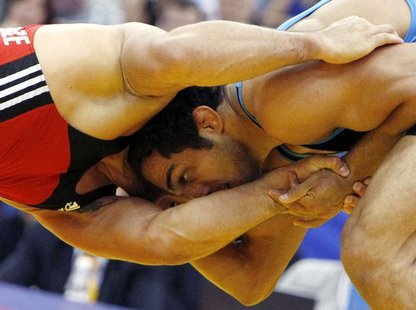 Georgia's George Goghelidze challenges Iran's Arfan Moradali Amiri (red) during their 96kg men's freestyle bronze medal match at the World W Georgia's George Goghelidze challenges Iran's Arfan Moradali Amiri (red) during their 96kg men's freestyle bronze medal match at the World W