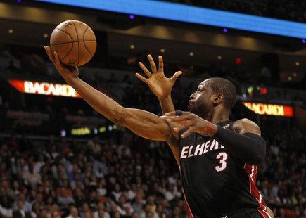 Miami Heat guard Dwyane Wade scores a basket against the Orlando Magic during their NBA basketball game at the American Airlines Arena in Mi Miami Heat guard Dwyane Wade scores a basket against the Orlando Magic during their NBA basketball game at the American Airlines Arena in Mi