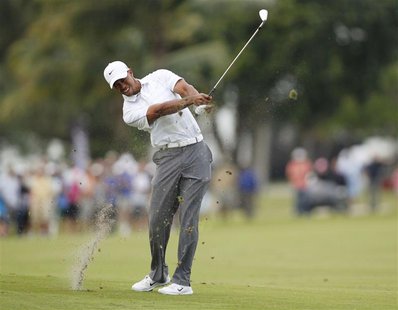 Tiger Woods hits his approach shot into the 18th green during third round play in the 2013 WGC-Cadillac Championship PGA golf tournament in Tiger Woods hits his approach shot into the 18th green during third round play in the 2013 WGC-Cadillac Championship PGA golf tournament in