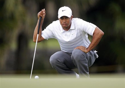 Tiger Woods lines up a putt on the 13th green during third round play in the 2013 WGC-Cadillac Championship PGA golf tournament in Doral, Fl Tiger Woods lines up a putt on the 13th green during third round play in the 2013 WGC-Cadillac Championship PGA golf tournament in Doral, Fl