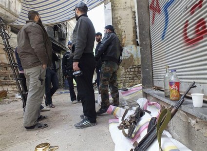 Free Syrian Army fighters stand by their weapons in the besieged area of Homs, March 9, 2013. Picture taken March 9, 2013. REUTERS/Yazan Hom Free Syrian Army fighters stand by their weapons in the besieged area of Homs, March 9, 2013. Picture taken March 9, 2013. REUTERS/Yazan Hom