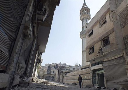 A Free Syrian Army fighter walks along a damaged street in the besieged area of Homs, March 9, 2013. Picture taken March 9, 2013. REUTERS/Ya A Free Syrian Army fighter walks along a damaged street in the besieged area of Homs, March 9, 2013. Picture taken March 9, 2013. REUTERS/Ya