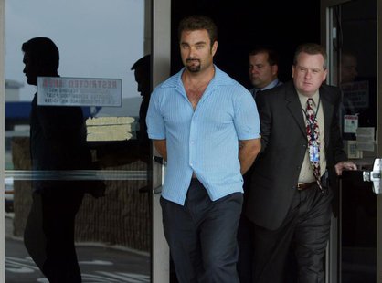Fugitive rapist Andrew Luster (L) is led out of the U.S. Customs building by federal agents after arriving at Los Angeles International Airp Fugitive rapist Andrew Luster (L) is led out of the U.S. Customs building by federal agents after arriving at Los Angeles International Airp