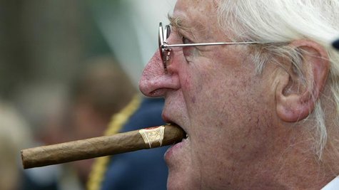British entertainer Sir Jimmy Savile arrives at the unveiling of a new monument, commemorating the fighter pilots who fought in the Battle o British entertainer Sir Jimmy Savile arrives at the unveiling of a new monument, commemorating the fighter pilots who fought in the Battle o