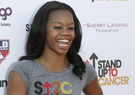 Olympic gold medal gymnast Gabrielle Douglas arrives for the Stand Up To Cancer fundraising telethon at the Shrine Auditorium in Los Angeles Olympic gold medal gymnast Gabrielle Douglas arrives for the Stand Up To Cancer fundraising telethon at the Shrine Auditorium in Los Angeles