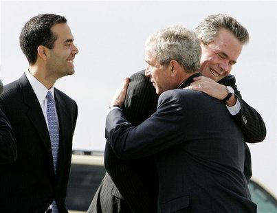 U.S. President George W. Bush (C) hugs his brother, former Florida Gov. Jeb Bush (R), while Jeb's son George P. Bush (L) smiles after arrivi U.S. President George W. Bush (C) hugs his brother, former Florida Gov. Jeb Bush (R), while Jeb's son George P. Bush (L) smiles after arrivi