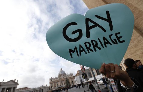 A member of a gay activist group holds a sign in front of St. Peter's square in the Vatican December 16, 2012. REUTERS/Alessandro Bianchi A member of a gay activist group holds a sign in front of St. Peter's square in the Vatican December 16, 2012. REUTERS/Alessandro Bianchi