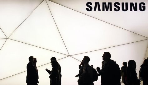 People walk past a Samsung stand at the Mobile World Congress in Barcelona February 25, 2013. REUTERS/Albert Gea People walk past a Samsung stand at the Mobile World Congress in Barcelona February 25, 2013. REUTERS/Albert Gea