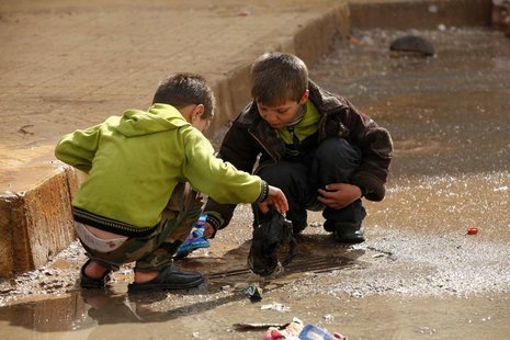 Children remove trash blocking the drains in the Al Inzarat district in Aleppo February 17, 2013. REUTERS/Hamid Khatib Children remove trash blocking the drains in the Al Inzarat district in Aleppo February 17, 2013. REUTERS/Hamid Khatib