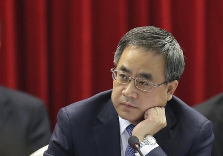Guangdong Communist Party Secretary Hu Chunhua listens to a delegate while attending the Guangdong delegation's group discussion during the Guangdong Communist Party Secretary Hu Chunhua listens to a delegate while attending the Guangdong delegation's group discussion during the