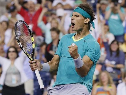 Rafael Nadal of Spain celebrates defeating Ernests Gulbis of Latvia during the third set of their men's singles match at the BNP Paribas Ope Rafael Nadal of Spain celebrates defeating Ernests Gulbis of Latvia during the third set of their men's singles match at the BNP Paribas Ope