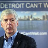 Michigan Governor Rick Snyder talks about the city of Detroit being in a financial emergency state during a meeting with an invited audience