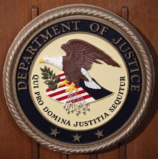 The Department of Justice logo is seen on the podium during a news conference on the Gozi Virus in New York January 23, 2013. REUTERS/Carlo The Department of Justice logo is seen on the podium during a news conference on the Gozi Virus in New York January 23, 2013. REUTERS/Carlo