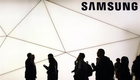 People walk past a Samsung stand at the Mobile World Congress in Barcelona February 25, 2013. REUTERS/Albert Gea People walk past a Samsung stand at the Mobile World Congress in Barcelona February 25, 2013. REUTERS/Albert Gea