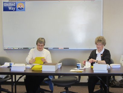 Two United Way volunteers stuff envelopes with this year's LIFE Report survey Two United Way volunteers stuff envelopes with this year's LIFE Report survey