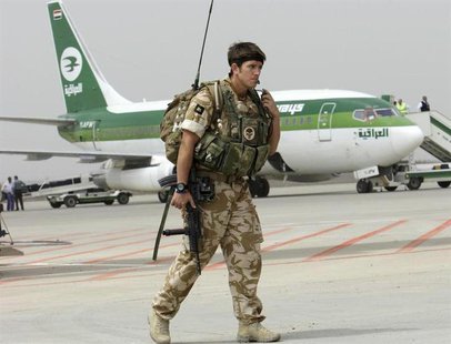A British soldier walks on the tarmac near an Iraqi Airways Boeing 737 plane, during the handover ceremony of Basra's international airport A British soldier walks on the tarmac near an Iraqi Airways Boeing 737 plane, during the handover ceremony of Basra's international airport
