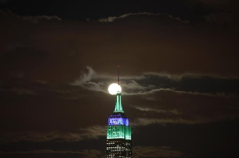 A full moon rises behind the Empire State Building in New York as seen from a park along the Hudson River in Hoboken, New Jersey, February 2 A full moon rises behind the Empire State Building in New York as seen from a park along the Hudson River in Hoboken, New Jersey, February 2