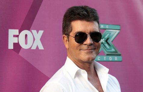 Judge Simon Cowell poses at the season two premiere of the television series "The X Factor" at Grauman's Chinese theatre in Hollywood, Calif Judge Simon Cowell poses at the season two premiere of the television series "The X Factor" at Grauman's Chinese theatre in Hollywood, Calif