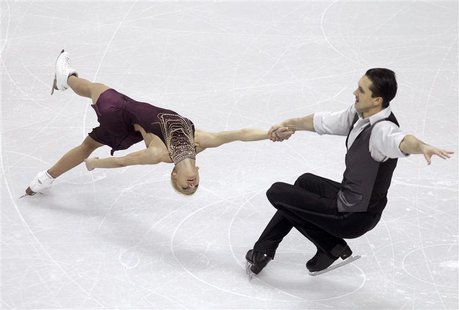 Tatiana Volosozhar (L) and Maxim Trankov of Russia perform their pairs short program at the ISU World Figure Skating Championships in London Tatiana Volosozhar (L) and Maxim Trankov of Russia perform their pairs short program at the ISU World Figure Skating Championships in London