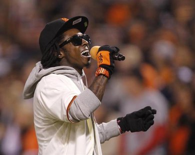 Rapper Lil Wayne sings "Take Me Out To The Ball Game" during the seventh inning stretch in Game 6 of the MLB NLCS playoff baseball series be Rapper Lil Wayne sings "Take Me Out To The Ball Game" during the seventh inning stretch in Game 6 of the MLB NLCS playoff baseball series be