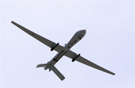 A U.S. Air Force MQ-1 Predator, unmanned aerial vehicle, armed with AGM-114 Hellfire missiles, performs a low altitude pass during the Aviat A U.S. Air Force MQ-1 Predator, unmanned aerial vehicle, armed with AGM-114 Hellfire missiles, performs a low altitude pass during the Aviat