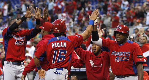 Puerto Rico's Angel Pagan (C) high fives with teammates after scoring the run driven in by Mike Aviles in the first inning of their 2013 Wor Puerto Rico's Angel Pagan (C) high fives with teammates after scoring the run driven in by Mike Aviles in the first inning of their 2013 Wor