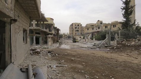 A view shows damaged buildings and a vehicle on a deserted street in Deraa February 22, 2013. Picture taken February 22, 2013. REUTERS/Ali A A view shows damaged buildings and a vehicle on a deserted street in Deraa February 22, 2013. Picture taken February 22, 2013. REUTERS/Ali A