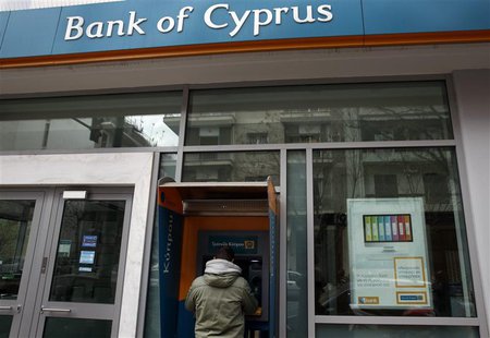 A man withdraws money from an automatic teller machine at a branch of Bank of Cyprus, in Athens March 16, 2013. REUTERS/Yannis Behrakis A man withdraws money from an automatic teller machine at a branch of Bank of Cyprus, in Athens March 16, 2013. REUTERS/Yannis Behrakis