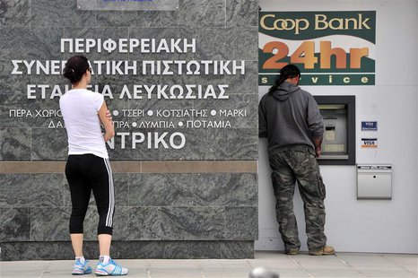 People gather at an automatic teller machine in Nicosia March 16, 2013. REUTERS/Yiannis Nisiotis People gather at an automatic teller machine in Nicosia March 16, 2013. REUTERS/Yiannis Nisiotis