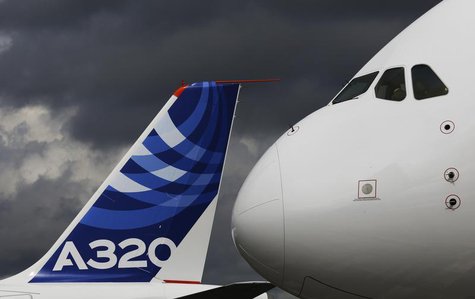 The nose cone of an Airbus A380 overlooks the tail fin of an Airbus A320 at the Farnborough Airshow 2012 in southern England July 10, 2012. The nose cone of an Airbus A380 overlooks the tail fin of an Airbus A320 at the Farnborough Airshow 2012 in southern England July 10, 2012.