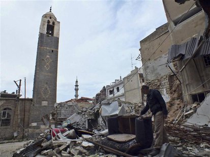 A man inspects rubble and trash in Al-Hamidiya neighbourhood in Homs March 16, 2013. REUTERS/Yazen Homsy A man inspects rubble and trash in Al-Hamidiya neighbourhood in Homs March 16, 2013. REUTERS/Yazen Homsy