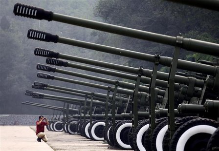 A visitor to the China Aviation Museum, located on the outskirts of Beijing, takes a photograph of a row of old anti-aircraft guns on displa A visitor to the China Aviation Museum, located on the outskirts of Beijing, takes a photograph of a row of old anti-aircraft guns on displa