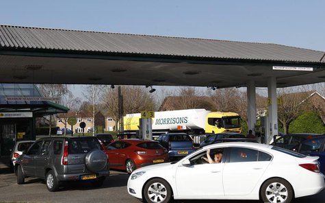 A petrol tanker driver makes a delivery as drivers queue for fuel in Loughborough, central England March 28, 2012. REUTERS/Darren Staples A petrol tanker driver makes a delivery as drivers queue for fuel in Loughborough, central England March 28, 2012. REUTERS/Darren Staples