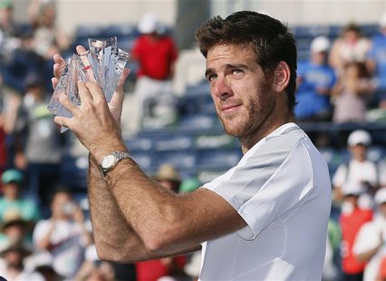 Juan Martin Del Potro of Argentina holds his runner's up trophy after losing to Rafael Nadal of Spain in the men's singles final match at th Juan Martin Del Potro of Argentina holds his runner's up trophy after losing to Rafael Nadal of Spain in the men's singles final match at th