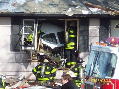 Firefighters and rescue workers look over the scene in South Bend, Indiana in this March 17, 2013 photo courtesy WNDU-TV after a small twin- Firefighters and rescue workers look over the scene in South Bend, Indiana in this March 17, 2013 photo courtesy WNDU-TV after a small twin-