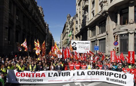 People hold banners and placards as they march during a protest against government austerity measures in Barcelona March 10, 2013. REUTERS/A People hold banners and placards as they march during a protest against government austerity measures in Barcelona March 10, 2013. REUTERS/A