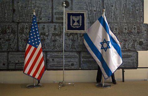 An employee arranges an Israeli national flag next to a U.S. one at the residence of Israel's President Shimon Peres in Jerusalem, ahead of An employee arranges an Israeli national flag next to a U.S. one at the residence of Israel's President Shimon Peres in Jerusalem, ahead of