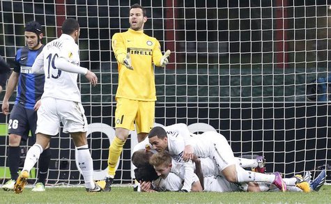 Tottenham Hotspur's Emmanuel Adebayor (bottom) celebrates with team mates after scoring against Inter Milan during their Europa League socce Tottenham Hotspur's Emmanuel Adebayor (bottom) celebrates with team mates after scoring against Inter Milan during their Europa League socce